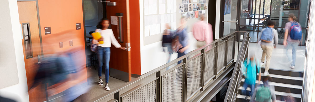 A school hallway with students moving quickly between classes.
