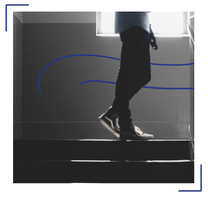 A student lingers in a school stairway.